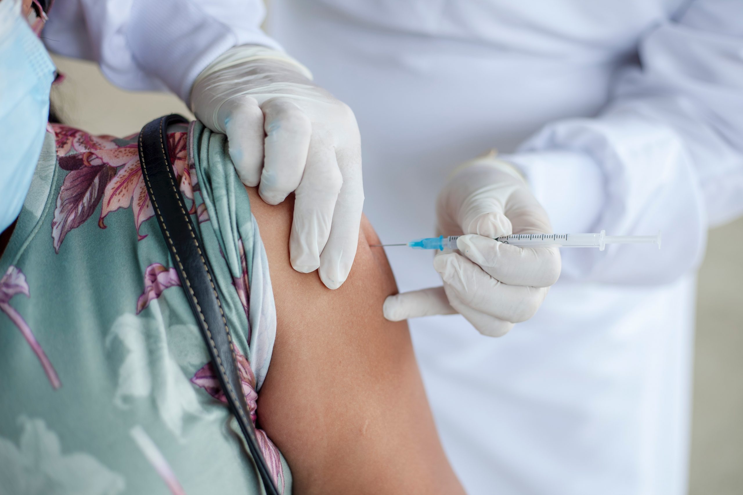 person getting injection from a doctor