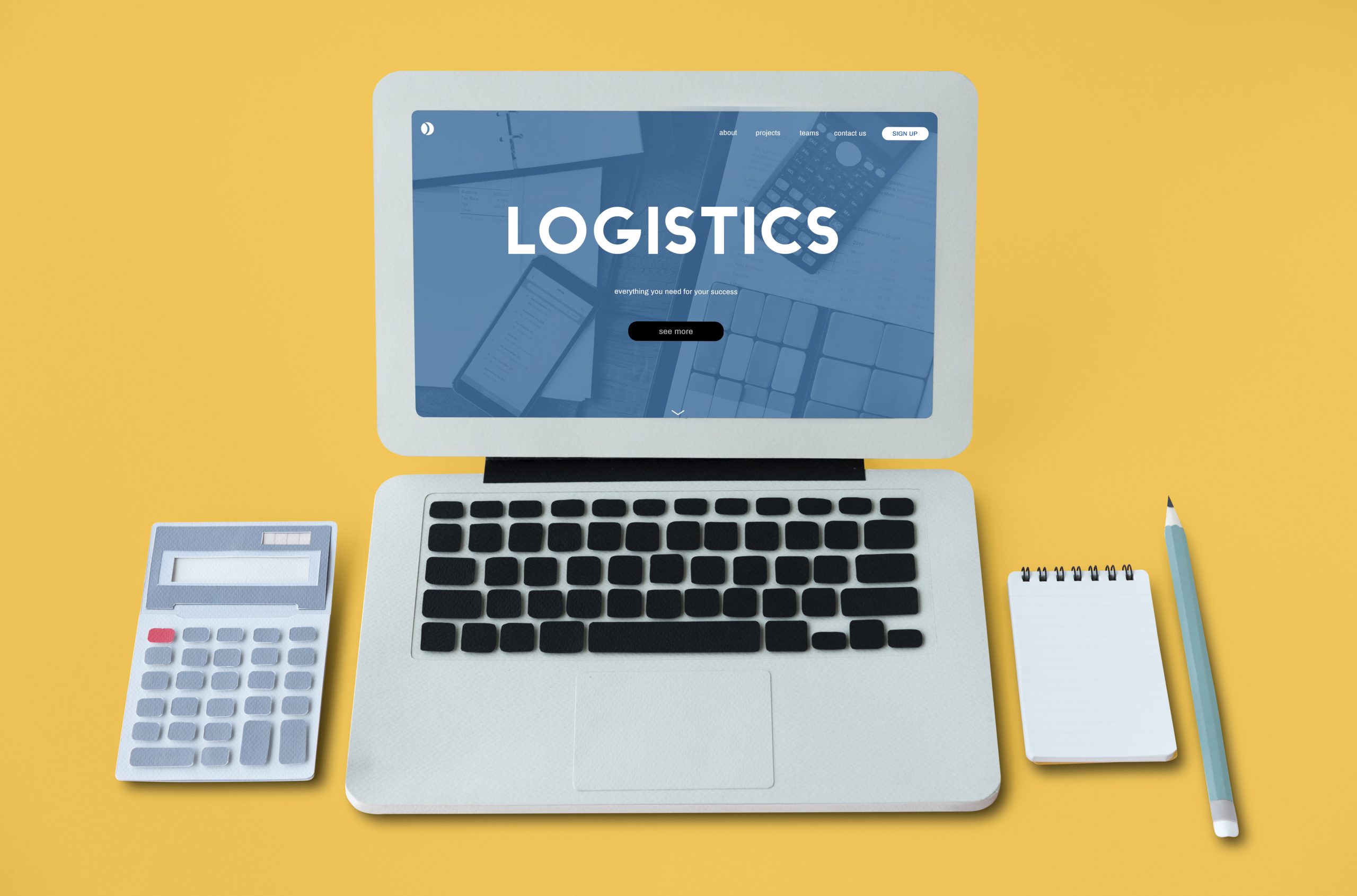 a laptop, calculator, a notepad and a pen to illustrate the concept of logistics and procurement