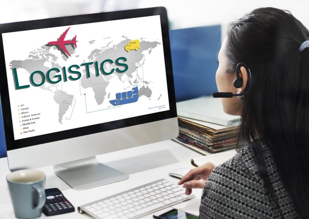 Woman infront of a computer working on a logistics freight management concept