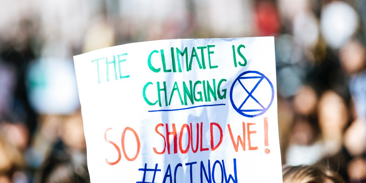 white placard that talks about climate change