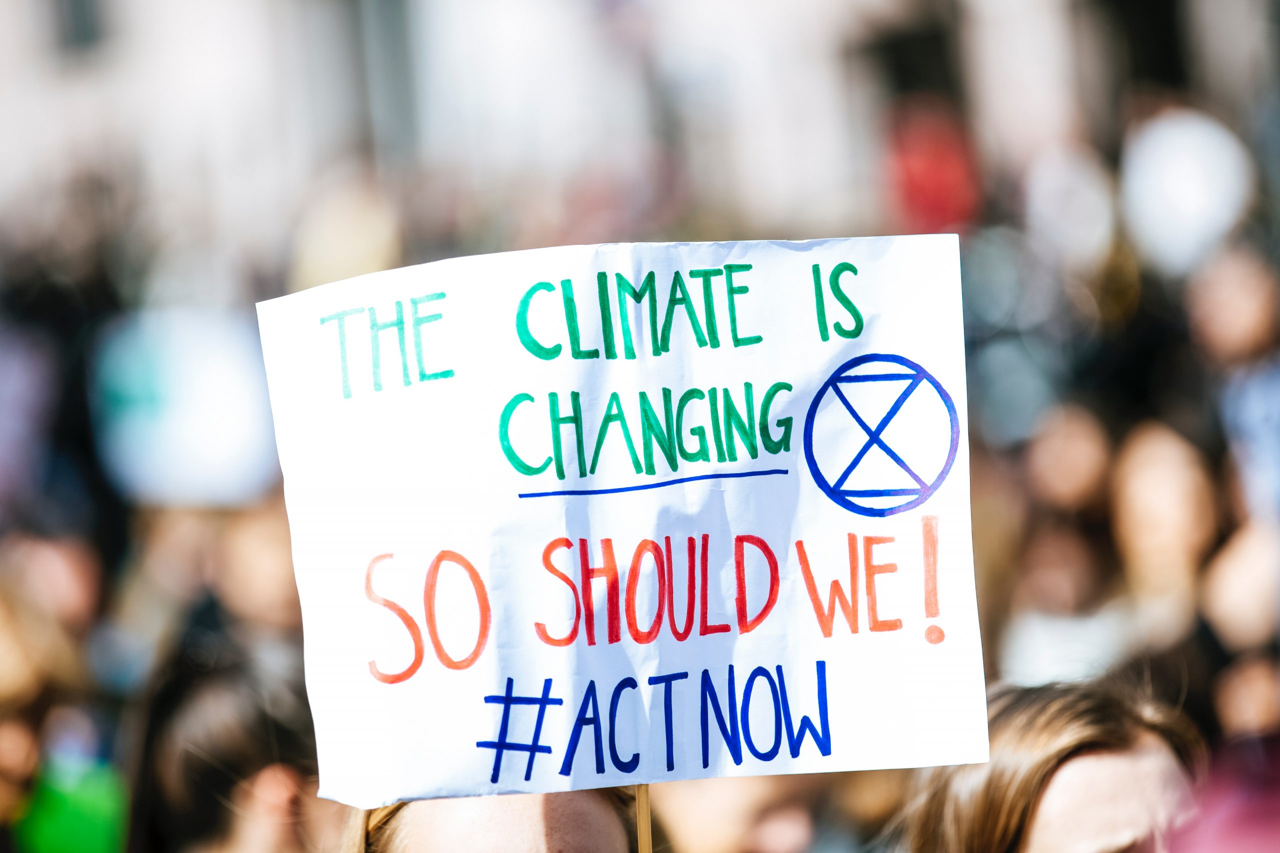 white placard that talks about climate change