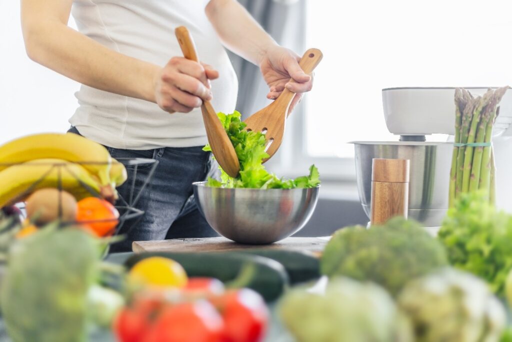 A pregnant woman preparing healthy food