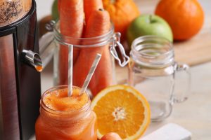 Fresh juice strained from oranges and carrots served as a source of vitamin A