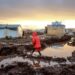 A little girl walking on mud in a displacement camp