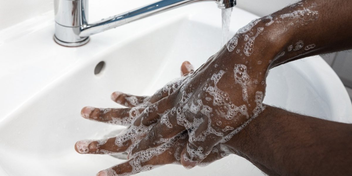 a person washing their hands to maintain hygiene