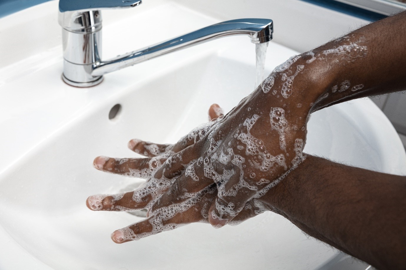 a person washing their hands to maintain hygiene