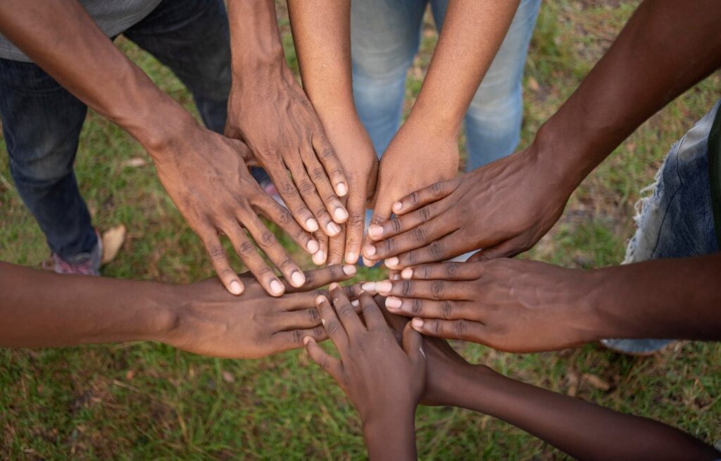 people putting hands together in the sense of community