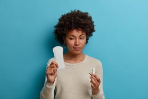 a lady holding a sanitary pad to demonstrate menstrual health